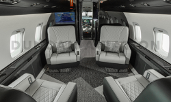 Gray leather club seats with black and white interior in Challenger 604