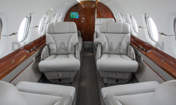 Updated interior of Hawker 800 in cool gray and warm wood tones