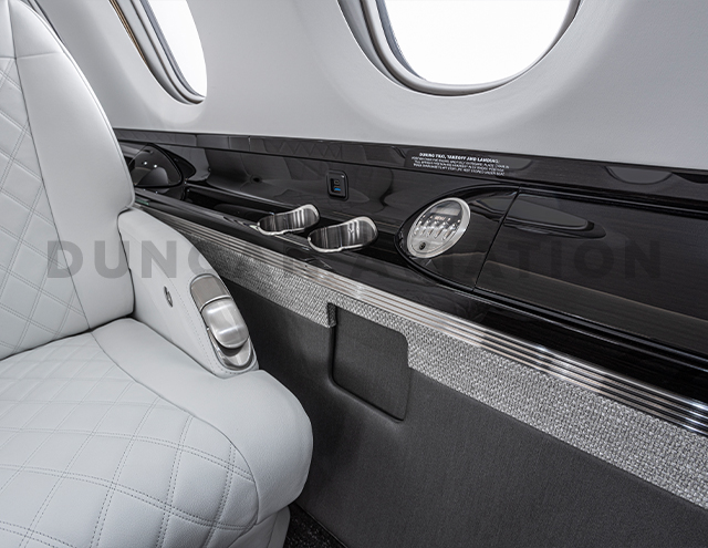 Black lacquer drink rail with white leather club seat in Hawker 800