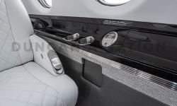 Black lacquer drink rail with white leather club seat in Hawker 800