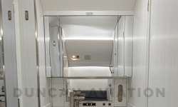 All white lavatory with gold hardware in Falcon 2000 interior refurbishment