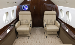 Interior of newly refurbished Falcon 2000 by Duncan Aviation with tan upholstery and dark wood accents