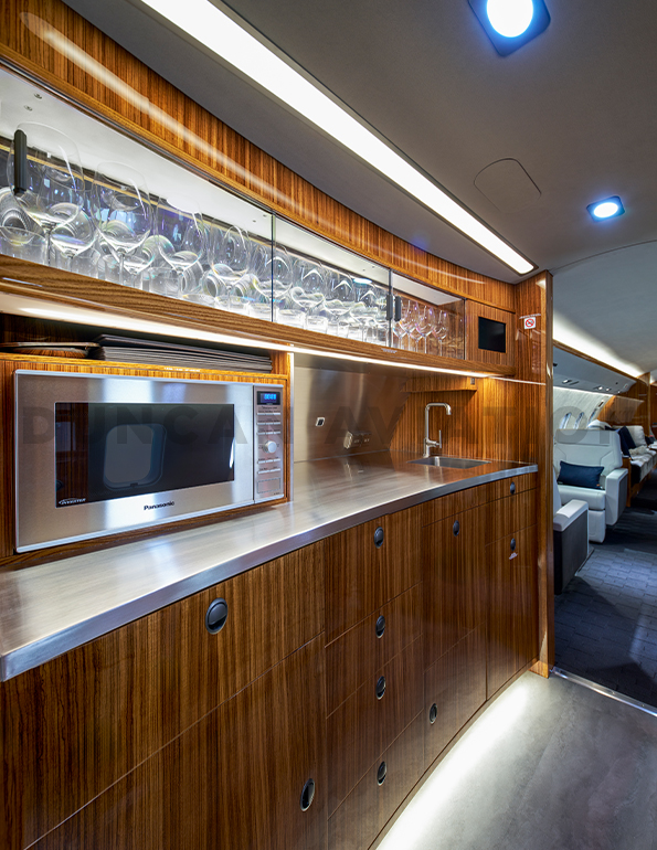 Refurbished galley with warm wood tones in Global Express