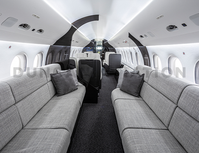 Modern gray facing divans of interior refurbishment in Falcon 2000