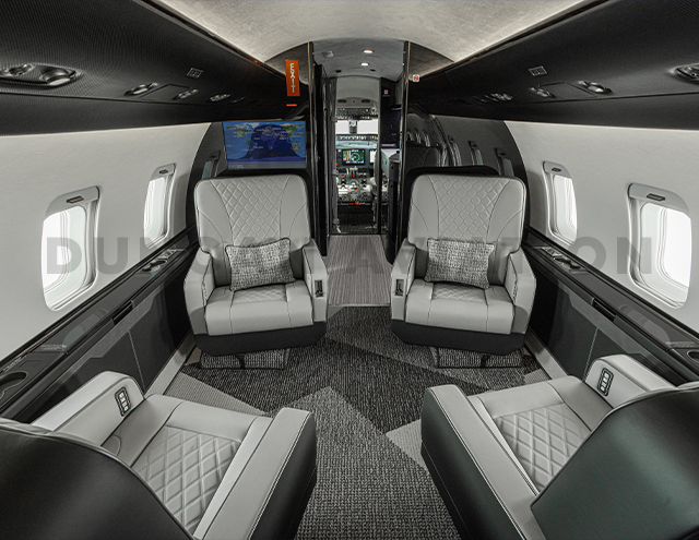 Gray leather club seats with black and white interior in Challenger 604