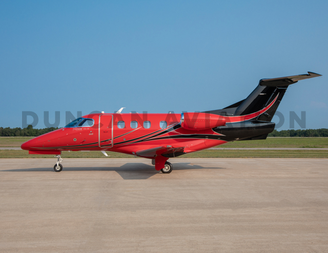 Exterior of Phenom 100 with hot red and black paint
