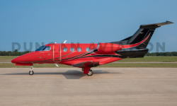 Exterior of Phenom 100 with hot red and black paint