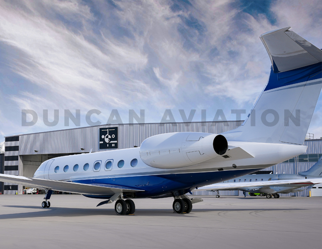 Exterior photo from the rear of aircraft of new paint on a Gulfstream 650 with Duncan Aviation hangar in background