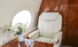 Cream leather captain chair and retractable table inside refurbished Gulfstream 650