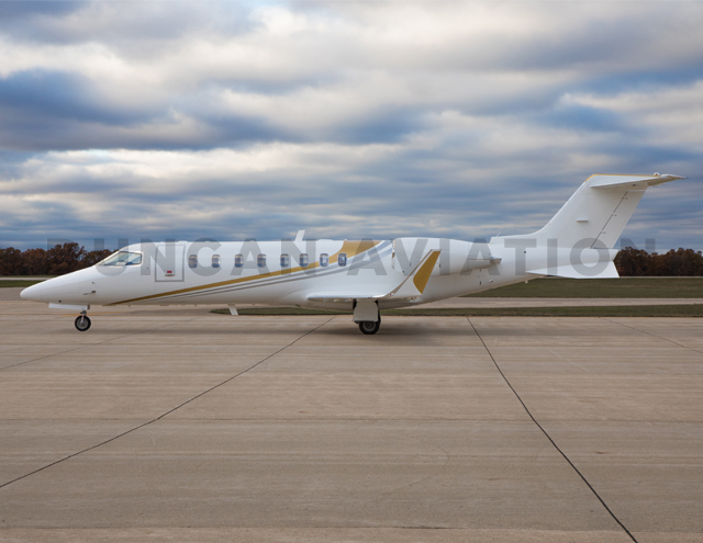 Learjet 45 exterior with white paint and gold accents