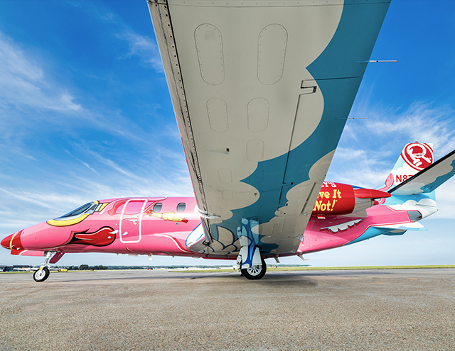 Under wing view of the Ripley's Believe It or Not! Flying Pig Citation by Duncan Aviation