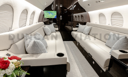 Matching facing cream leather divan couches in newly refurbished Falcon 7X