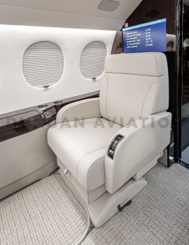 Cream leather captain chair in refurbished Falcon 7X by Duncan Aviation