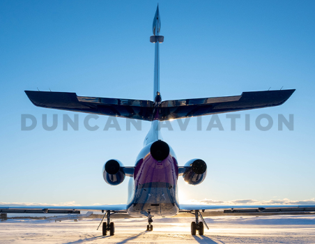 Refurbished paint by Duncan Aviation on Falcon 900 in dark blue, magenta, and light blue